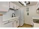 Bright kitchen featuring white cabinets, modern appliances, and subway tile backsplash at 8555 Fairmount Dr # C202, Denver, CO 80247