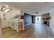 Open-concept living area with modern kitchen, stone fireplace, and sliding glass doors at 8555 Fairmount Dr # C202, Denver, CO 80247