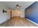 Spacious living room with ceiling fan, and open layout with colorful accent wall at 8555 Fairmount Dr # C202, Denver, CO 80247