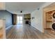 Open living area with a stone fireplace, modern flooring, and convenient laundry access at 8555 Fairmount Dr # C202, Denver, CO 80247