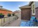 Cozy backyard deck with outdoor seating, potted plants, and brick exterior at 14641 E Poundstone Dr, Aurora, CO 80015