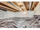 Unfinished basement space featuring a vapor barrier and exposed beams at 14641 E Poundstone Dr, Aurora, CO 80015