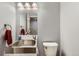 Compact bathroom features a stainless steel sink and a white toilet at 14641 E Poundstone Dr, Aurora, CO 80015