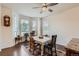 Bright dining room with hardwood floors, a bay window, and a ceiling fan at 14641 E Poundstone Dr, Aurora, CO 80015