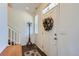 Bright entryway featuring a decorative autumn wreath, coat rack, and staircase at 14641 E Poundstone Dr, Aurora, CO 80015