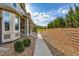 Landscaped home exterior with a well-maintained sidewalk and retaining wall at 14641 E Poundstone Dr, Aurora, CO 80015