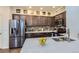 Well-equipped kitchen with stainless steel refrigerator and ample cabinet space at 14641 E Poundstone Dr, Aurora, CO 80015