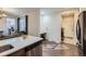 Bright open kitchen with stainless steel appliances and quartz countertops overlooks the living area at 14641 E Poundstone Dr, Aurora, CO 80015