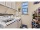 Convenient laundry room with washer, dryer, and storage cabinets at 14641 E Poundstone Dr, Aurora, CO 80015