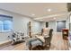 Inviting living room with modern flooring, comfortable seating, and a cozy cat tree at 14641 E Poundstone Dr, Aurora, CO 80015