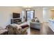 Inviting living room with a comfortable sofa, television, and access to a balcony at 14641 E Poundstone Dr, Aurora, CO 80015