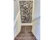 Staircase with hardwood steps and a large art piece at 14641 E Poundstone Dr, Aurora, CO 80015
