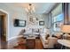 Living room with large gray sectional sofa, wood floors, and bright window with natural light at 3249 N Clay St, Denver, CO 80211