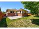 Backyard with a grass lawn and patio, plus a view of the home's exterior at 25077 E Canal Pl, Aurora, CO 80018