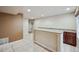 Basement wet bar with granite countertop and dark wood cabinets at 25077 E Canal Pl, Aurora, CO 80018