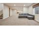 Spacious finished basement with L-shaped sectional sofa and carpet at 25077 E Canal Pl, Aurora, CO 80018