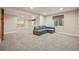Spacious finished basement with L-shaped sectional sofa and carpet at 25077 E Canal Pl, Aurora, CO 80018