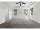 Bright and airy bedroom featuring plush carpeting, a tray ceiling, and windows that provide natural light at 25077 E Canal Pl, Aurora, CO 80018