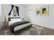 Cozy bedroom showcasing stylish decor, including modern artwork, neutral colors, and a geometric patterned rug at 25077 E Canal Pl, Aurora, CO 80018