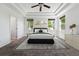 Inviting main bedroom featuring a tray ceiling, plush carpet, and plenty of natural light from the three windows at 25077 E Canal Pl, Aurora, CO 80018