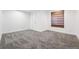 Unfurnished basement bedroom featuring neutral carpet, white walls, and a shade at 25077 E Canal Pl, Aurora, CO 80018