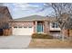 Brick ranch home with two-car garage and landscaped yard at 25077 E Canal Pl, Aurora, CO 80018