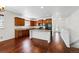 Efficient kitchen with ample cabinetry, black appliances, hardwood floors, and easy access to other rooms at 25077 E Canal Pl, Aurora, CO 80018