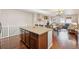 Kitchen island, hardwood floors, and open layout to living room at 25077 E Canal Pl, Aurora, CO 80018