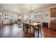Open kitchen with wood cabinets, island with seating, and hardwood floors at 25077 E Canal Pl, Aurora, CO 80018