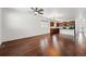 Spacious living area featuring hardwood floors leading into a kitchen with appliances and ample lighting at 25077 E Canal Pl, Aurora, CO 80018
