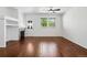 Inviting living room with hardwood floors, a cozy fireplace, and an abundance of natural light from windows at 25077 E Canal Pl, Aurora, CO 80018
