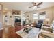 Open living room with hardwood floors, fireplace, and lots of natural light at 25077 E Canal Pl, Aurora, CO 80018