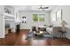 Bright living room with a fireplace, hardwood floors, and natural light from large windows at 25077 E Canal Pl, Aurora, CO 80018