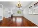 Spacious living area features gleaming hardwood floors, a fireplace, and a ceiling fan for added comfort at 25077 E Canal Pl, Aurora, CO 80018