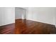 An empty, well-lit living room features hardwood floors and a staircase leading to the upper level at 25077 E Canal Pl, Aurora, CO 80018