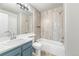 Bathroom with updated tile shower over tub, modern vanity and sink at 9477 W Ontario Dr, Littleton, CO 80128