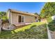 A well-maintained backyard features a sliding glass door and brick patio for outdoor entertaining at 5037 Pelican St, Brighton, CO 80601