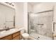 Accessible bathroom showcasing a glass-enclosed walk-in shower and vanity with sink at 5037 Pelican St, Brighton, CO 80601