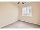 Neutral bedroom with a large window offering natural light and a ceiling fan for climate control at 5037 Pelican St, Brighton, CO 80601