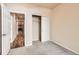 Bedroom with closet, open doorway to kitchen; neutral walls, carpeted floor, and good lighting at 5037 Pelican St, Brighton, CO 80601