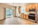 Modern kitchen features stainless steel appliances, wood cabinets, and sliding door leading to a private backyard at 5037 Pelican St, Brighton, CO 80601