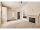 Bright living room featuring carpeted floors, fireplace, and ample natural light, creating an inviting atmosphere at 5037 Pelican St, Brighton, CO 80601