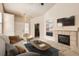 Cozy living room with fireplace, neutral colors, and comfortable seating, perfect for relaxing and entertaining at 5037 Pelican St, Brighton, CO 80601