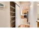 Walk-in pantry with adjustable wire shelves, adjacent to the kitchen for convenient storage at 5037 Pelican St, Brighton, CO 80601