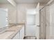 Stylish bathroom featuring a dual sink vanity, granite counters, and a glass-enclosed shower at 7244 Arkansas St, Frederick, CO 80530
