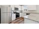 Modern kitchen featuring stainless steel appliances, granite countertops, and bright white cabinetry at 7244 Arkansas St, Frederick, CO 80530
