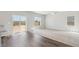 Bright living room with carpet and wood flooring plus large windows with natural light and sliding glass door at 7244 Arkansas St, Frederick, CO 80530