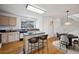 Kitchen with an island, light wood cabinets, and stainless steel appliances at 1415 S Ulster St, Denver, CO 80231