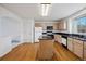 Kitchen with center island, light wood cabinets and black countertops at 1415 S Ulster St, Denver, CO 80231