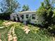 An overgrown backyard of a single Gathering house with assorted objects at 1266 Del Mar Pkwy, Aurora, CO 80010